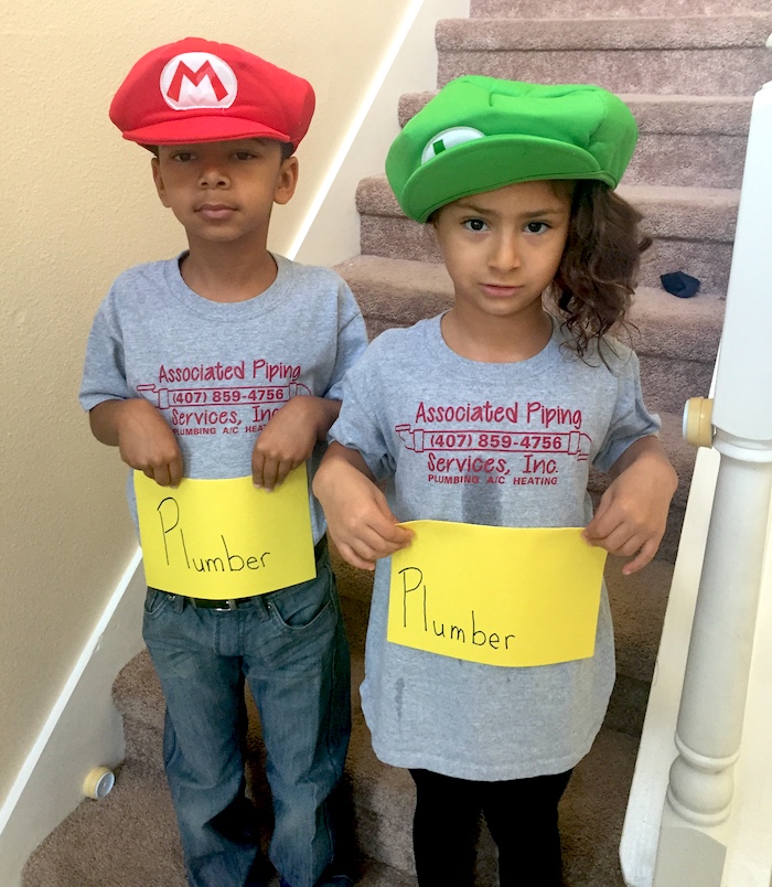 kids in mario and luigi hats holding plumber sign 2